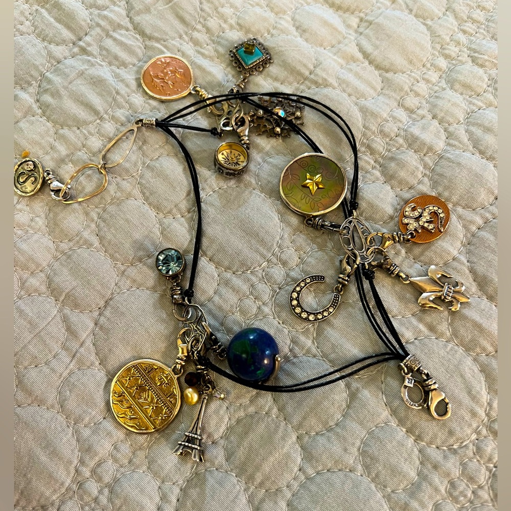 Silpada sterling silver bracelet with 13 charms attached.